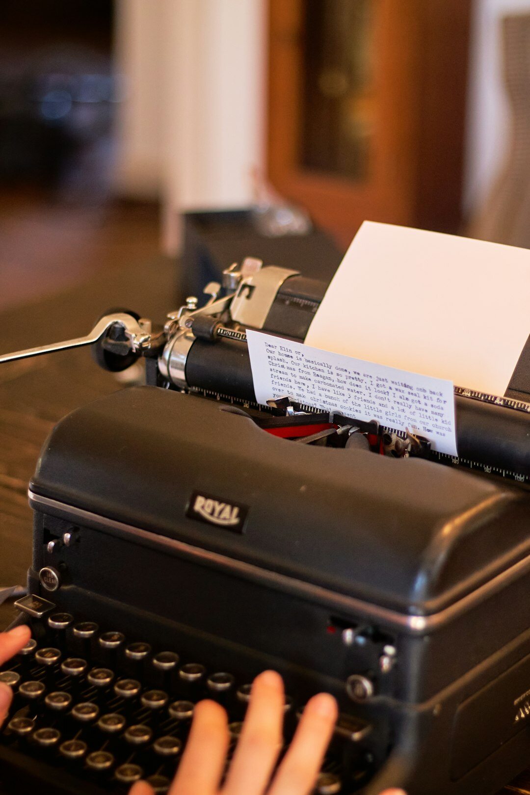 author writing at typewriter